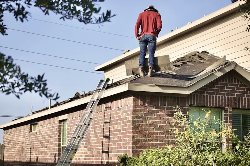 Professional roofer working on a residential roof in Louisville